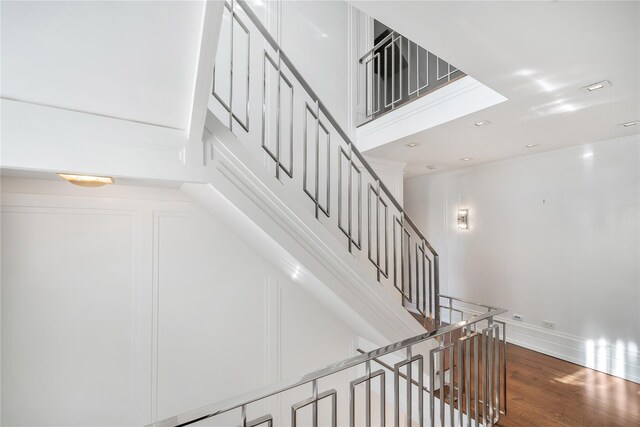 stairs with recessed lighting, wood finished floors, and baseboards