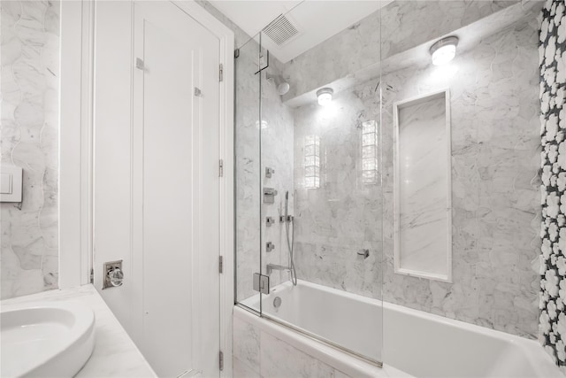 full bathroom featuring visible vents, a combined bath / shower with marble appearance, and vanity