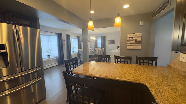 dining room with dark wood-style floors, recessed lighting, and a baseboard heating unit