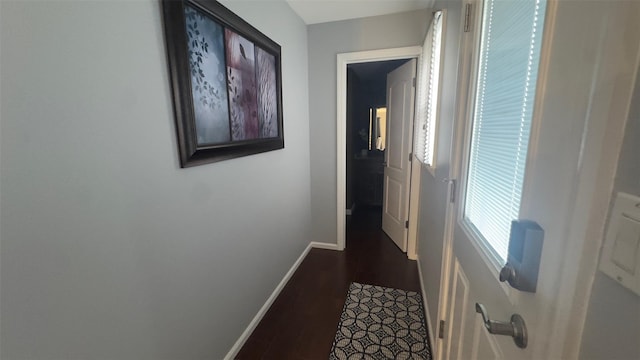 hall with baseboards and dark wood-style flooring