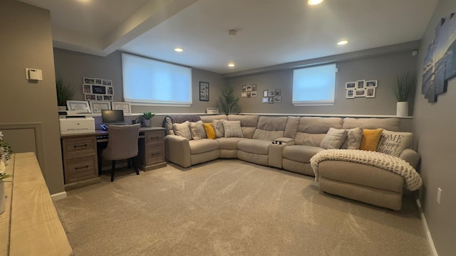 living area featuring recessed lighting, baseboards, light carpet, and built in study area