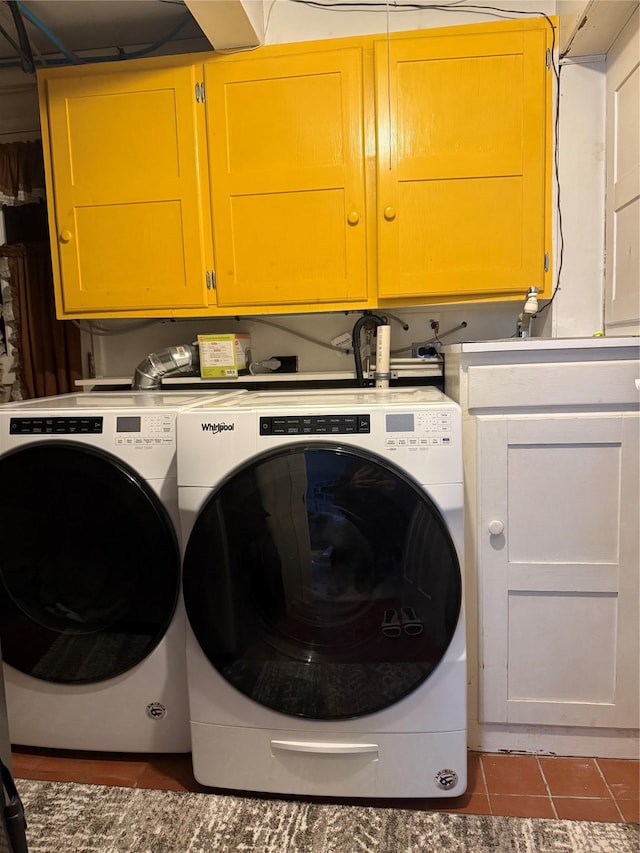 clothes washing area with separate washer and dryer, cabinet space, and tile patterned floors