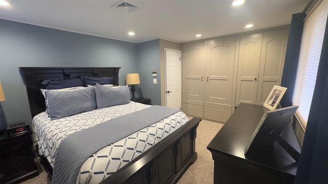 carpeted bedroom with a closet, visible vents, and recessed lighting