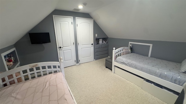 carpeted bedroom with visible vents and lofted ceiling