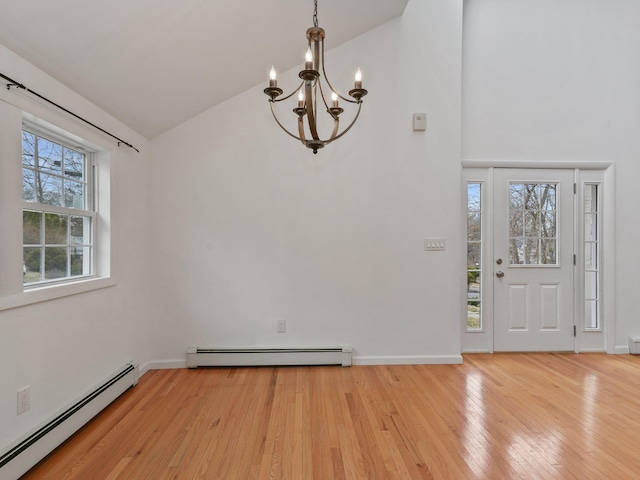 entrance foyer featuring a baseboard radiator, baseboards, and light wood-style floors