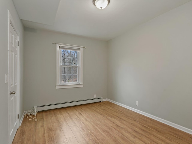 unfurnished bedroom with baseboards, light wood-type flooring, and baseboard heating