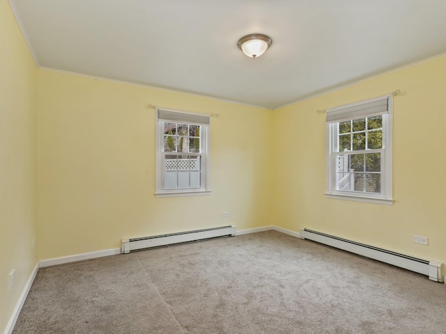 carpeted empty room with a baseboard radiator, baseboards, and ornamental molding