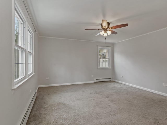 carpeted empty room featuring a baseboard heating unit, ceiling fan, baseboards, and ornamental molding