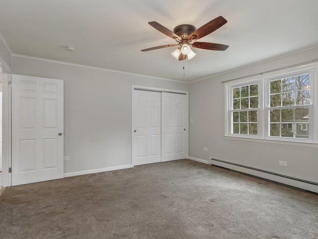 unfurnished bedroom featuring baseboards, a baseboard heating unit, carpet, and ornamental molding