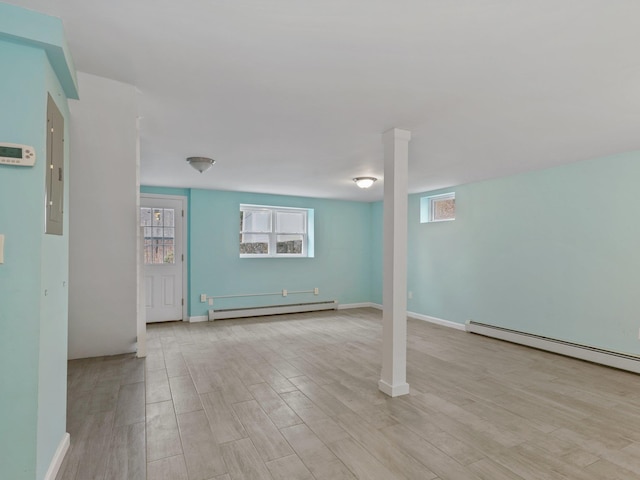 interior space with baseboards, light wood-style floors, and a baseboard radiator