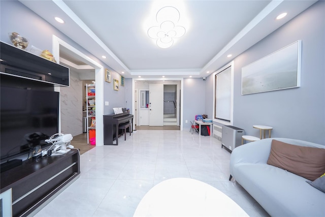 living area featuring recessed lighting, a tray ceiling, and light tile patterned flooring