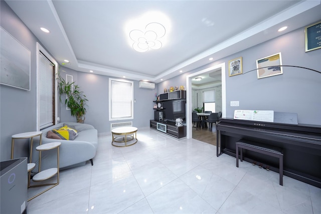 living room featuring recessed lighting, a tray ceiling, and a wall mounted AC