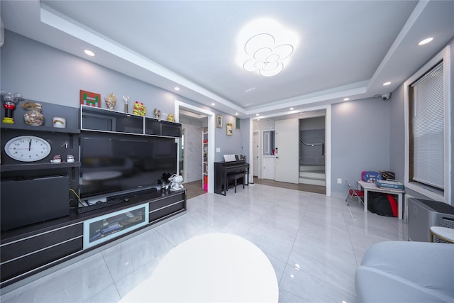 tiled living area with stairs, a tray ceiling, and recessed lighting