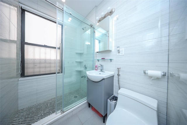 bathroom featuring plenty of natural light, tile walls, a stall shower, and vanity