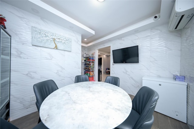 dining space with recessed lighting, tile walls, a wall mounted AC, and wood finished floors