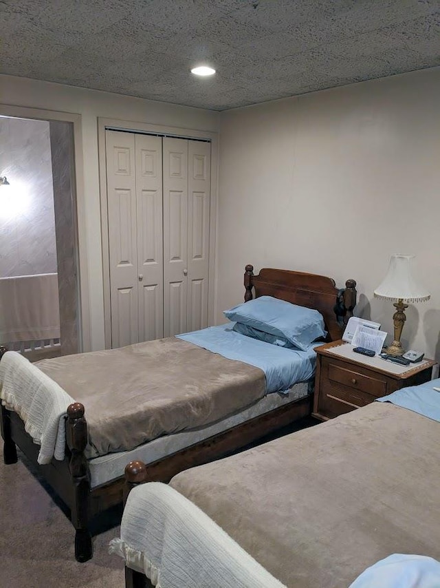 bedroom with a textured ceiling and a closet