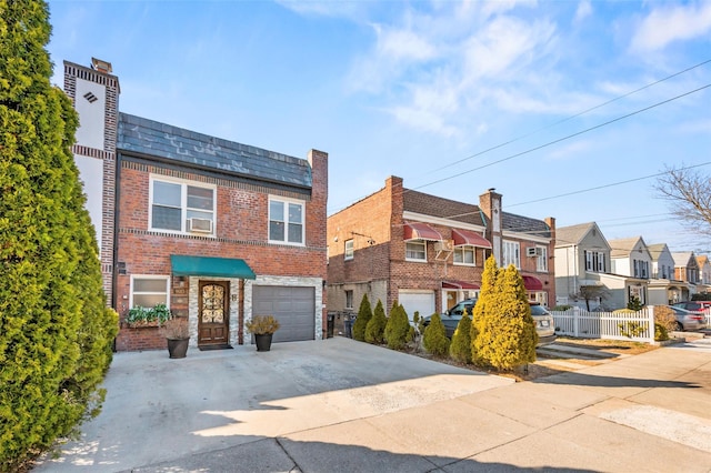 view of front facade featuring driveway, fence, a residential view, an attached garage, and brick siding