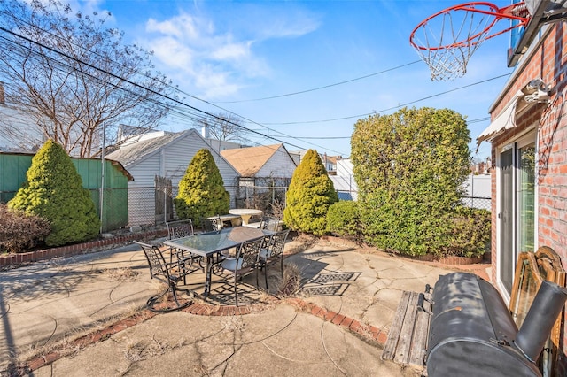 view of patio with outdoor dining area and fence