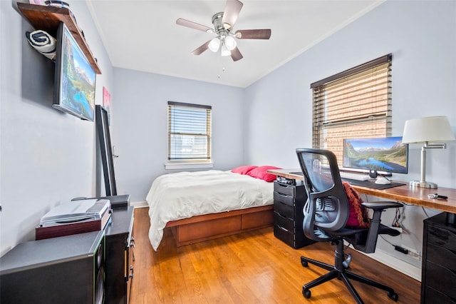 bedroom featuring baseboards, a ceiling fan, and wood finished floors