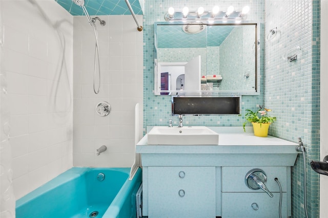 full bathroom with vanity, tile walls, backsplash, and shower / bath combination