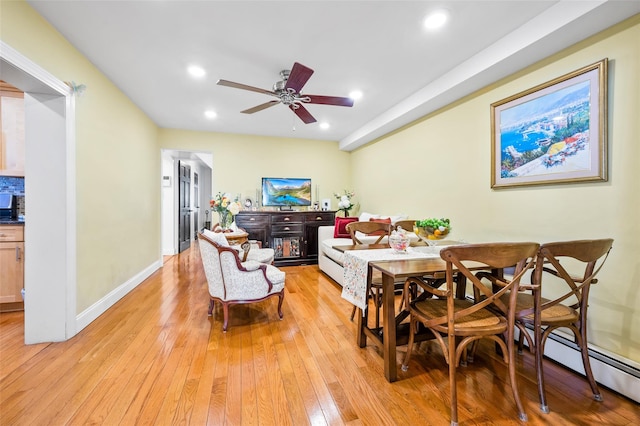 dining space featuring recessed lighting, baseboards, a fireplace, and light wood finished floors