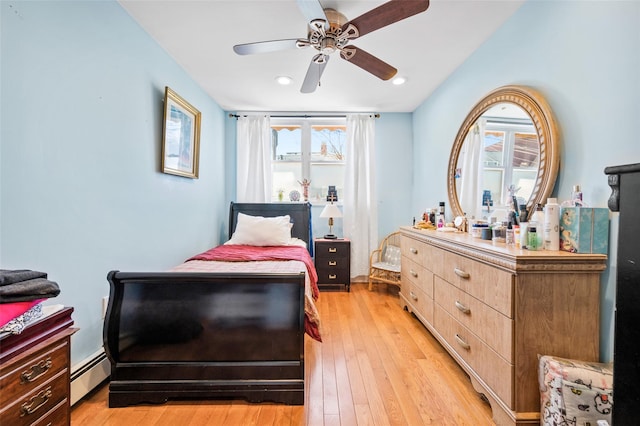 bedroom with a ceiling fan, recessed lighting, light wood-style floors, and baseboard heating