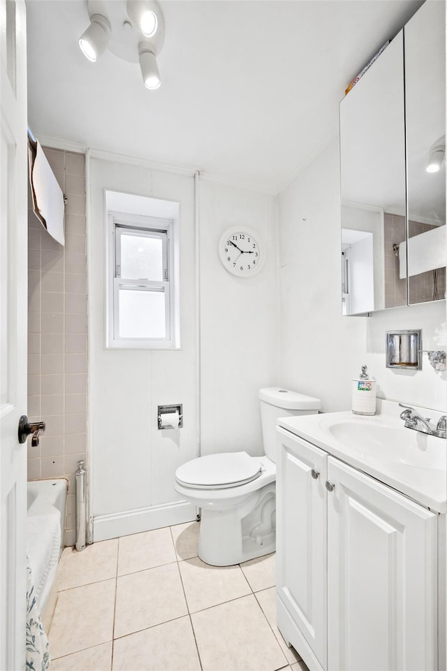 bathroom featuring tile patterned flooring, crown molding, toilet, and vanity