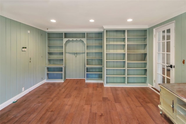 interior space with built in shelves, recessed lighting, baseboards, and wood finished floors