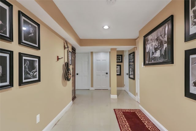 corridor with baseboards and recessed lighting