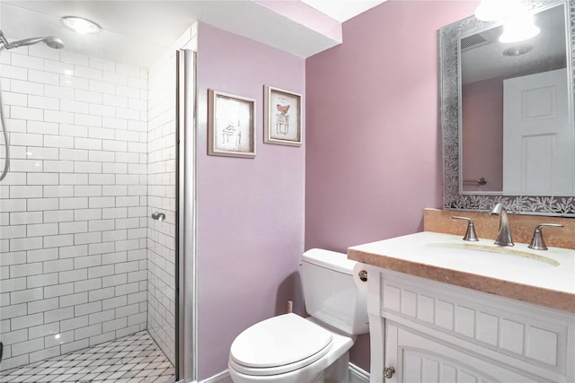 bathroom with toilet, a shower stall, and vanity