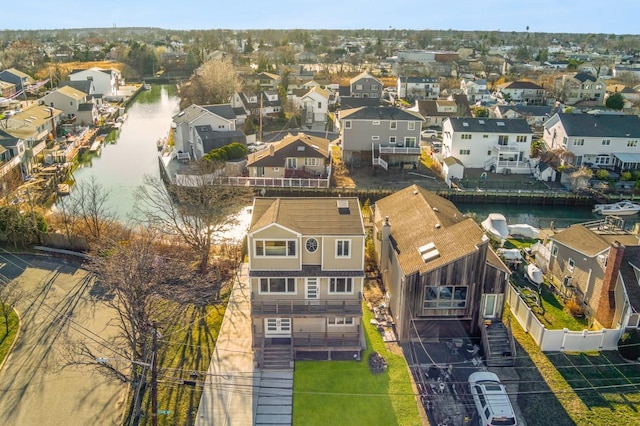 drone / aerial view with a water view and a residential view