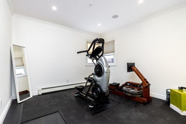 exercise room featuring a baseboard heating unit, baseboards, and ornamental molding