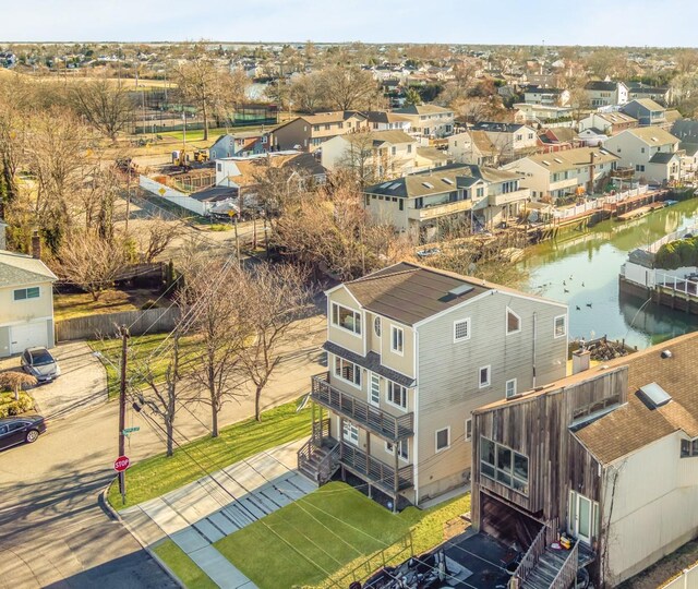 bird's eye view with a residential view and a water view