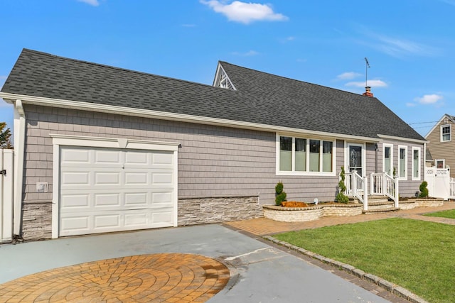 view of front facade with a garage, stone siding, driveway, and a shingled roof