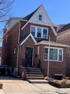 view of front of property featuring concrete driveway and brick siding