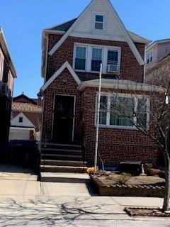 view of front of home featuring concrete driveway and brick siding