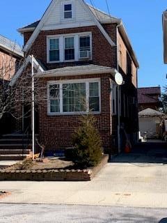 view of front of home featuring brick siding and driveway