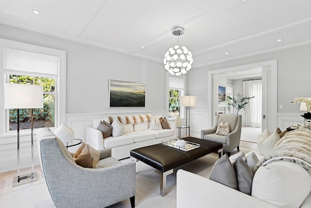 living area featuring wainscoting, an inviting chandelier, and a decorative wall