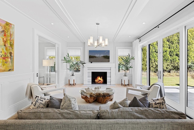 sunroom featuring a fireplace with flush hearth, a chandelier, and french doors