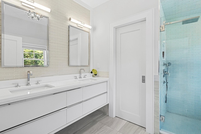 full bath with double vanity, a shower stall, and a sink