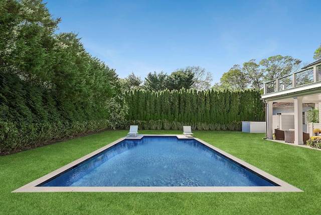 outdoor pool featuring a lawn