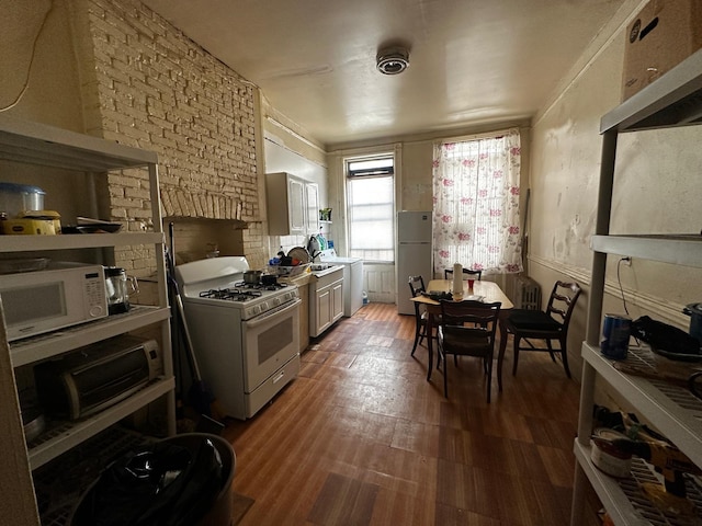 kitchen with white appliances and wood finished floors