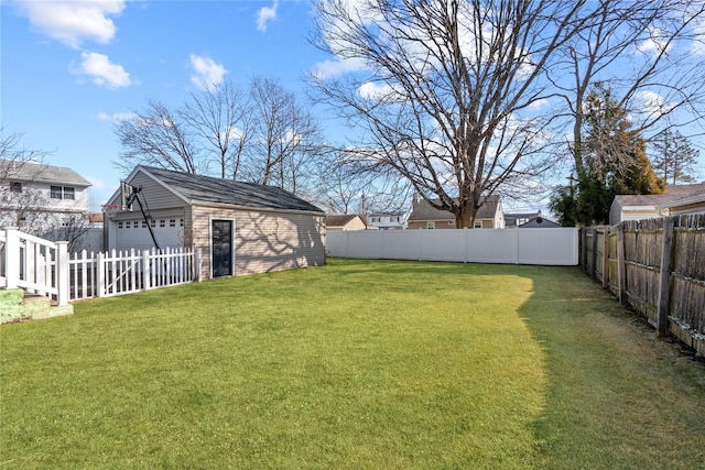 view of yard with an outbuilding, a fenced backyard, and a garage