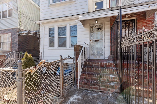 view of exterior entry featuring fence