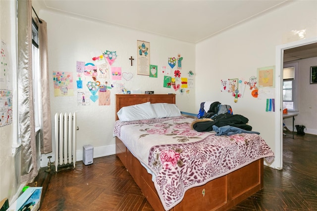 bedroom featuring radiator and baseboards