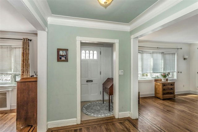 entryway with plenty of natural light, ornamental molding, and wood finished floors