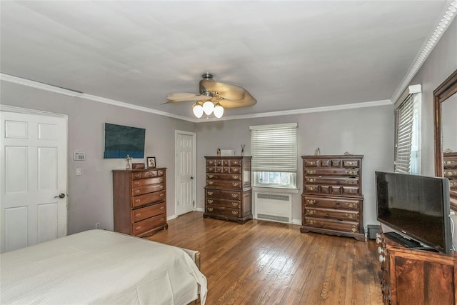 bedroom featuring multiple windows, radiator, ornamental molding, and hardwood / wood-style flooring