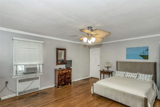 bedroom with radiator, wood finished floors, baseboards, and ornamental molding