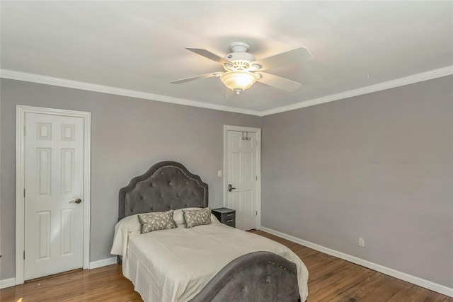 bedroom with crown molding, wood finished floors, baseboards, and ceiling fan