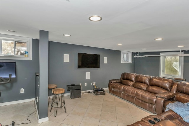 living room featuring recessed lighting, baseboards, and light tile patterned flooring